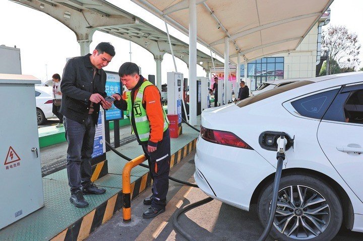 Tài xế sạc xe điện tại một trạm sác trên cao tốc ở tỉnh Tứ Xuyên, Trung Quốc. (Ảnh: Tân Hoa Xã)