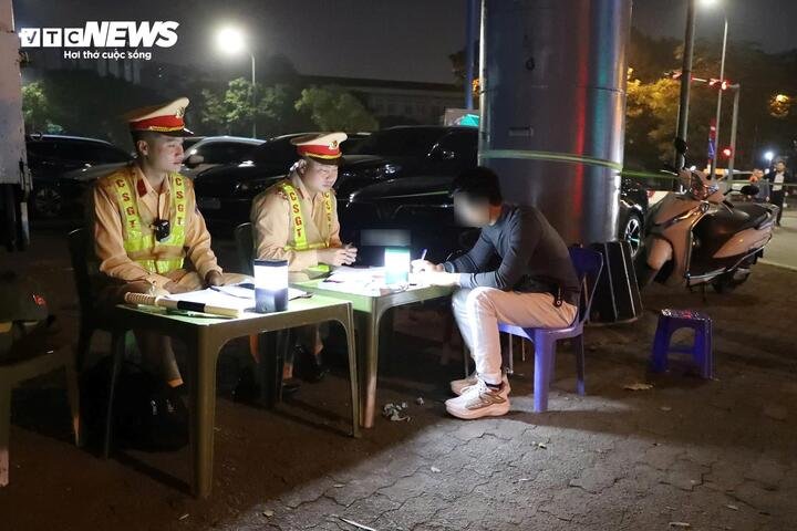 CSGT lập biên bản xử phạt tài xế H.N.T. sau khi phát hiện người này vi phạm nồng độ cồn.