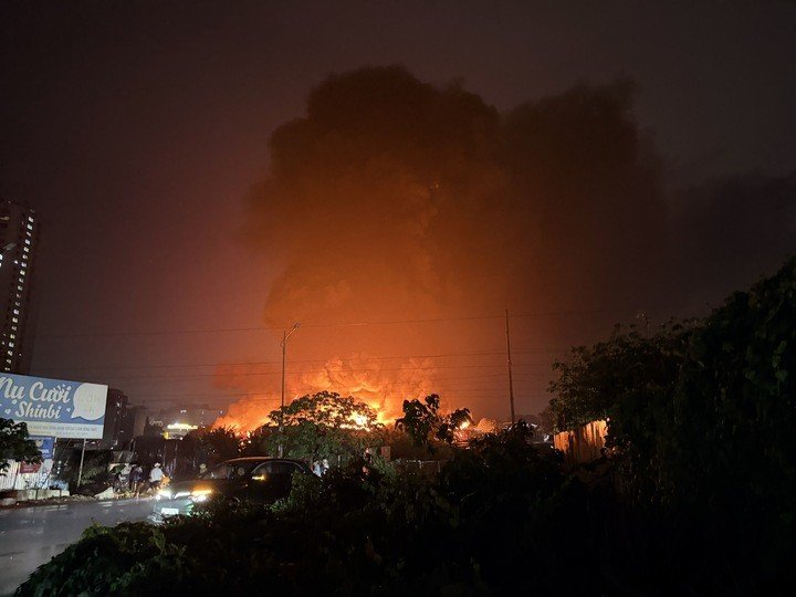 Bên trong xưởng gỗ chứa nhiều vật liệu dễ cháy, lửa nhanh chóng bao trùm toàn bộ nhà xưởng, tạo thành cột khói bốc cao.