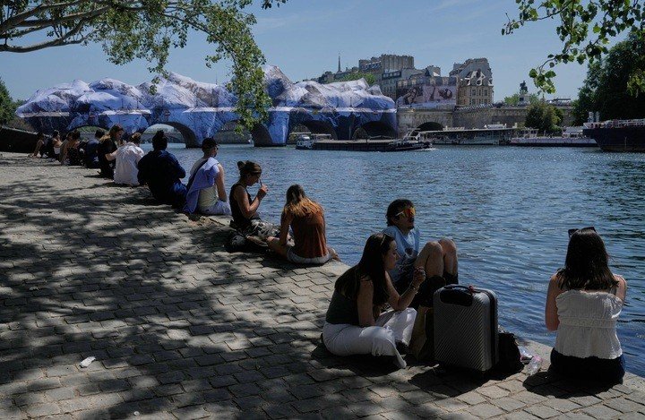 Người dân tìm cách tránh nóng dọc bờ sông Seine ở Paris, Pháp ngày 25/5/2026. (Ảnh: AP/Michel Euler)