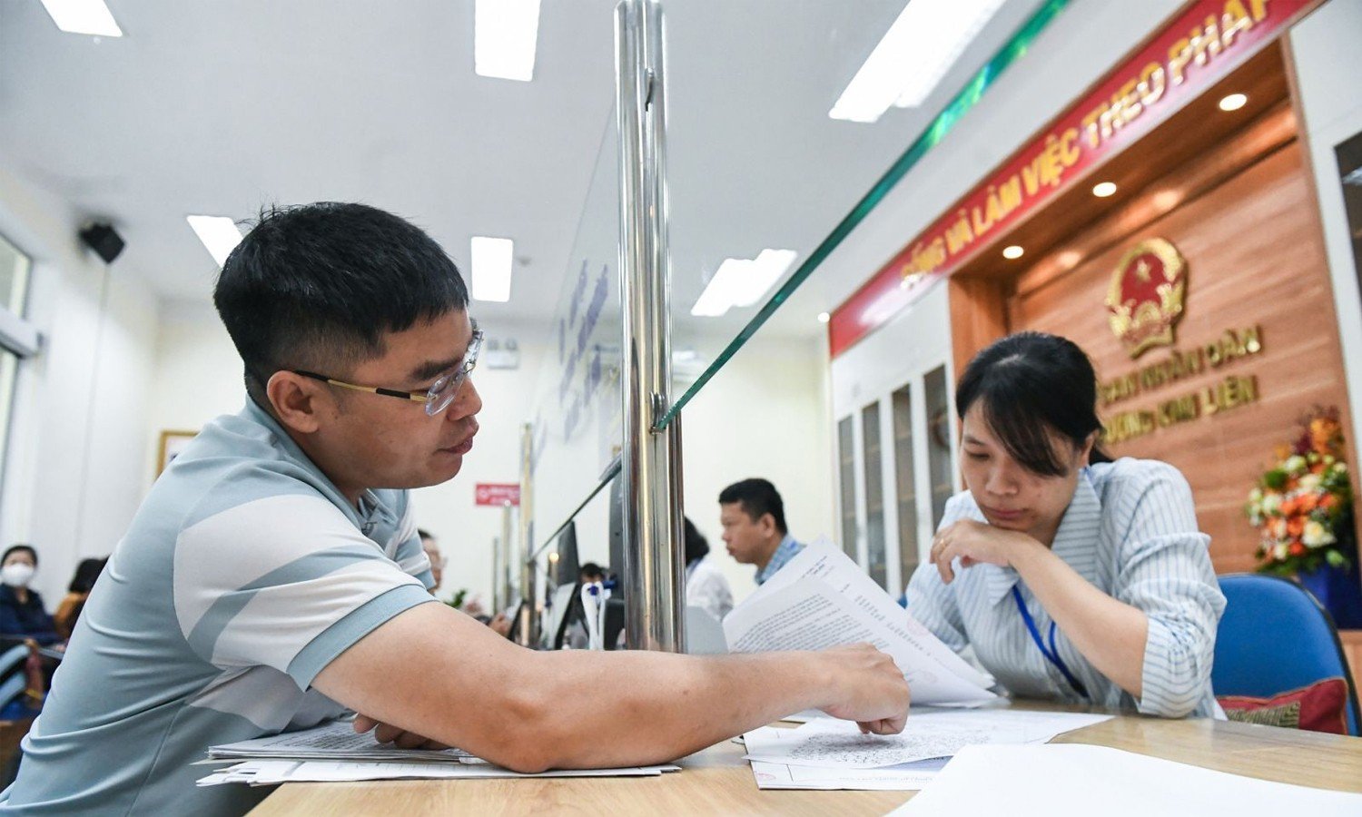 Cán bộ hỗ trợ người dân giải quyết thủ tục hành chính.