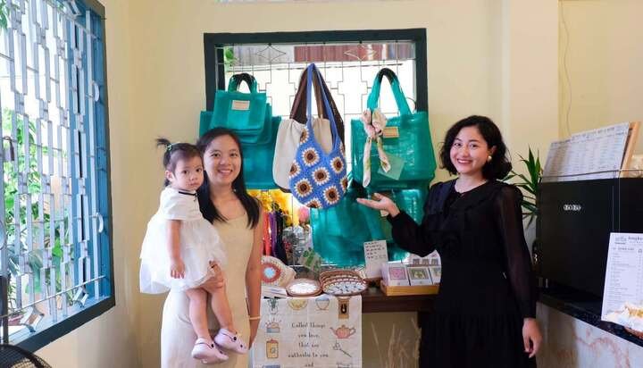 Chị Giang Châu (phải) và những mẫu túi được tái chế từ lưới đánh cá cũ.
