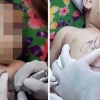 Clip em bé bị giữ chặt để xăm hình ở Việt Nam lên báo nước ngoài