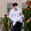Ảnh: Cảnh sát dẫn giải cựu Thứ trưởng Y tế Trương Quốc Cường tới toà