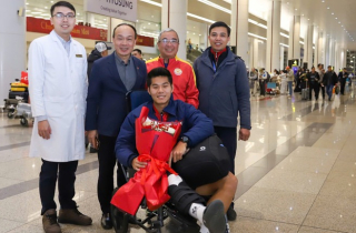 Hậu vệ U23 Việt Nam ngồi xe lăn xuống máy bay, bác sĩ đưa thẳng đến bệnh viện